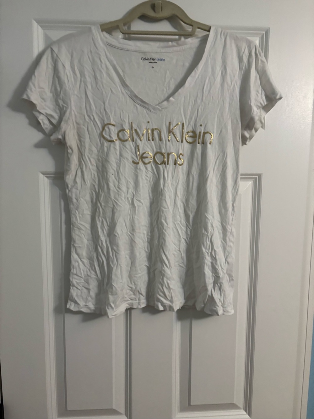 Calvin Klein Jeans Women's White V-Neck Tee with Gold Logo Script